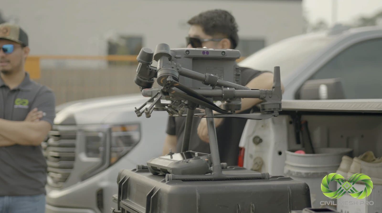Drone and survey equipment beside a pickup truck with the Civil Mesh team preparing for ground capture.